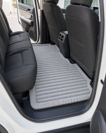 Plush car bed on a back seat floor