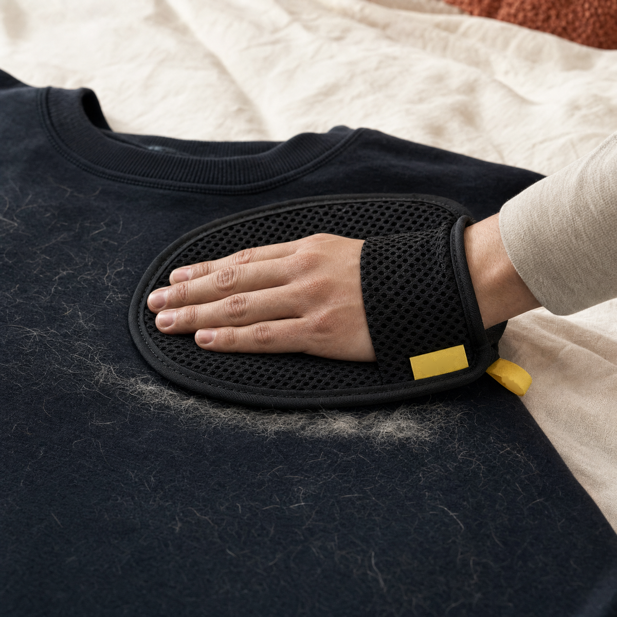 The glove removing fur from a sweatshirt
