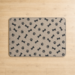Washable pee pad laid flat on a wood floor