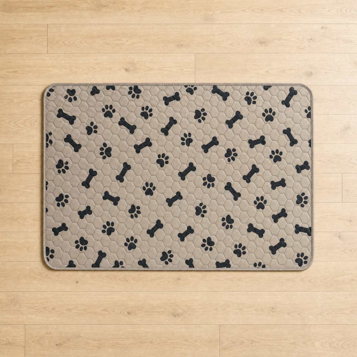 Washable pee pad laid flat on a wood floor